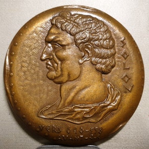 May include: Bronze medal featuring a profile portrait of a man with short, curly hair. The medal is inscribed with the word "SOLON" and the text "VERS 640 - 558 AVANT J.C."