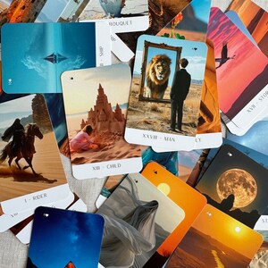 May include: A set of tarot cards with various images, including a rider on horseback, a ship, a child, a man, a sun, a house, a woman, a bouquet, and a stork. The cards are laid out on a beige surface.