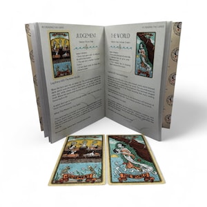 May include: An open book with the title "Reading the Cards" displays two tarot cards: "Judgement" and "The World." The book's pages feature text and illustrations. The cards are in a vintage style with detailed artwork and text.