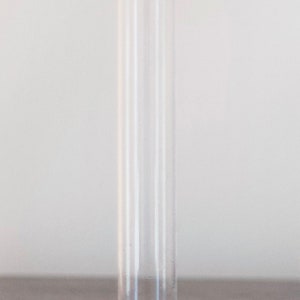 May include: A clear glass cylinder vase, perfect for displaying a single stem flower or a small bouquet.