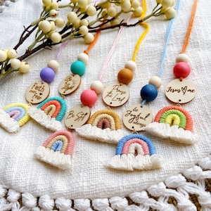 May include: A set of seven rainbow-themed wooden necklaces with colourful beads and inspirational messages. The messages include "Faith over Fear", "Be the Light", "Be Still", "Praise the Lord", "Be Joyful Always", and "Jesus Loves Me".