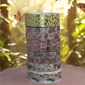 May include: A white ceramic mug with a black handle and the text "But First, Coffee" in a handwritten style. The mug is on a white surface. The mug is approximately 4 inches tall.