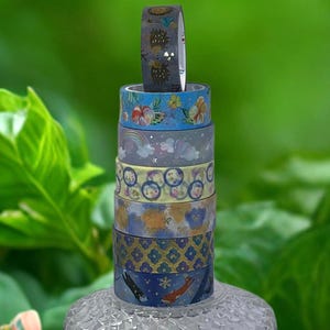 May include: A set of three ceramic mugs with a speckled, matte finish. The mugs are in shades of cream, light gray, and dark gray. Each mug has a simple, minimalist design, perfect for coffee or tea.