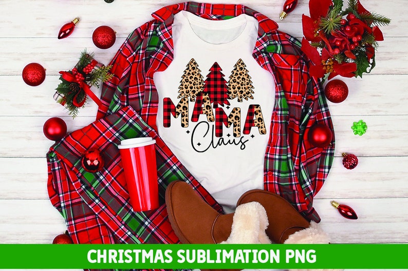 May include: White t-shirt with a Christmas design featuring three trees. The trees are decorated with red and black buffalo plaid and leopard print. The text "Mama Claus" is written in black with a buffalo plaid background.