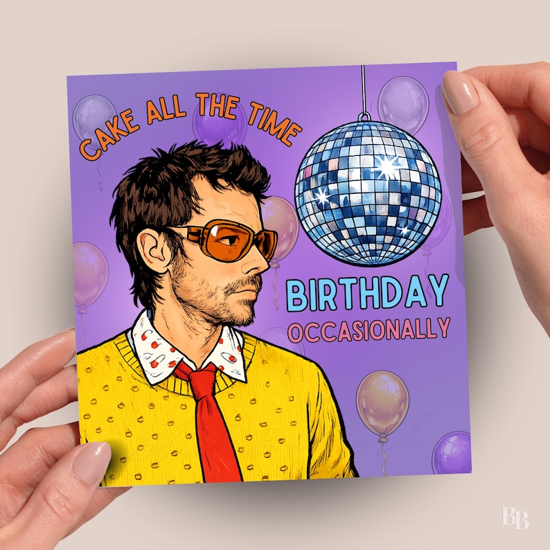 May include: A square greeting card with a purple background, featuring a cartoon illustration of a man wearing orange sunglasses, a yellow sweater, and a red tie. The card has the text "CAKE ALL THE TIME" and "BIRTHDAY OCCASIONALLY". A disco ball and balloons are also featured.