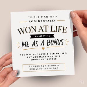 May include: A white card with gold text and accents. The card says "TO THE MAN WHO ACCIDENTALLY WON AT LIFE BY GETTING ME AS A BONUS." The bottom of the card says "THANKS FOR BEING A BRILLIANT STEP DAD."
