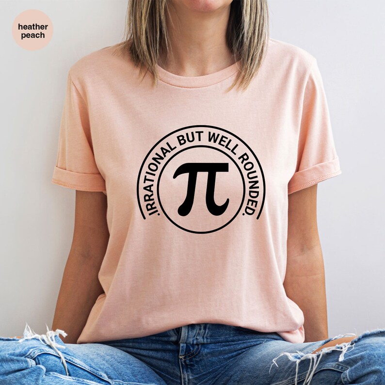 May include: A pink t-shirt with a black circle graphic that says "Irrational But Well Rounded" and has a pi symbol inside.