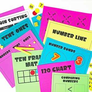 May include: A set of colourful educational games for children, including a coin sorting game, a tens and ones chart, a number line, a number bonds game, a ten frame mat, a 120 chart, and a comparing numbers game.