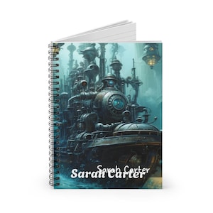 May include: Spiral-bound notebook with a steampunk illustration of a mechanical city in blue, brown, and grey. The name "Sarah Carter" is printed in white script at the bottom. The notebook has a white interior.