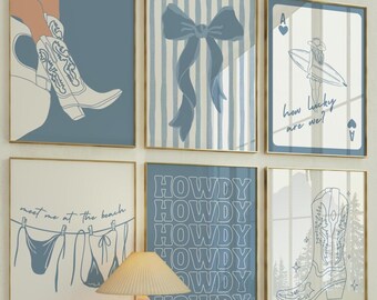 May include: A collection of six framed art prints with gold frames. The prints feature illustrations of a cowboy boot, a bow, a bikini, and the word "HOWDY". The color palette is primarily blue and white.
