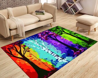 May include: A colorful area rug with a design of five trees in a rainbow pattern. The trees are silhouetted against a background of red, orange, yellow, green, blue, purple, and pink.