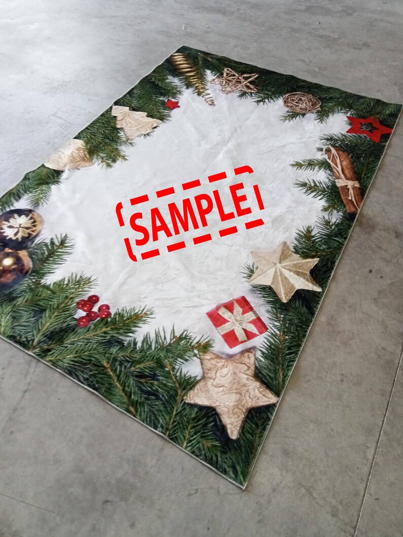 May include: Rectangular Christmas-themed rug with a white center and a border of green pine branches, gold ornaments, and red berries. The rug features gold stars, a red gift box, and the word "SAMPLE" in red.