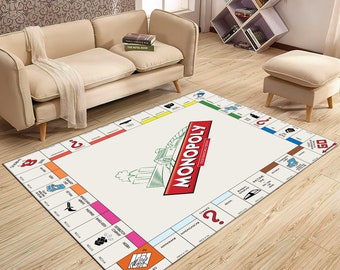 May include: A white Monopoly game board rug with a red Monopoly logo and a green train illustration. The rug has a white background with colorful squares and text.