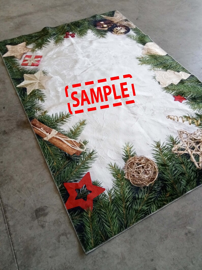 May include: Rectangular Christmas-themed table runner with a white center and a border of green pine needles. The border is decorated with red stars, gold stars, ornaments, and cinnamon sticks. The word "SAMPLE" is printed in red.