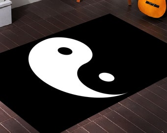 May include: A black and white rug with a yin yang symbol in the centre.