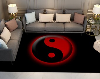 May include: A black and red yin yang symbol rug with a glowing effect. The rug is placed in a living room setting with two grey sofas and end tables with lamps.