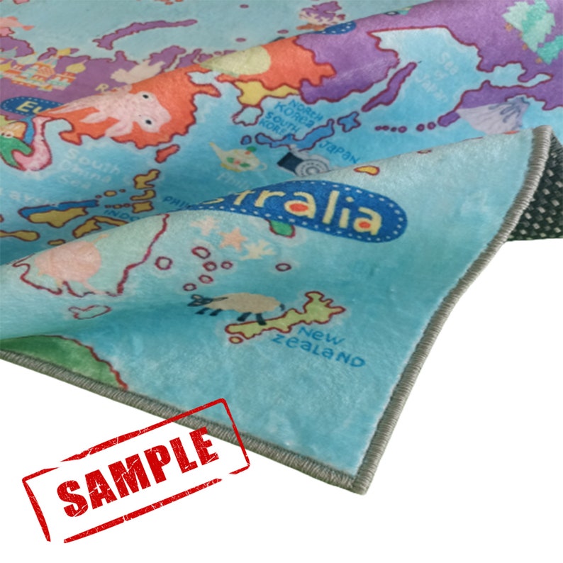 May include: A colorful rug featuring a world map design with continents and oceans in shades of blue, orange, purple, and green. The rug has a soft, plush texture and a gray border. The word "Australia" is visible on the rug.