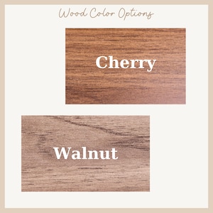 May include: Image showcasing two wood color options: Cherry and Walnut. The Cherry sample is a warm, reddish-brown hue, while the Walnut sample presents a cooler, medium brown tone. The text "Wood Color Options" is at the top.