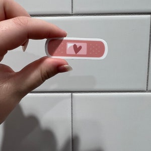 Pink heart bandaid sticker small