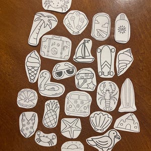 May include: A collection of black and white summer-themed stickers. The stickers include a crab, palm tree, seashell, airplane window, sunscreen, suitcase, sailboat, ice cream cone, sunglasses, flamingo float, skateboard, lobster, surfboard, and more.