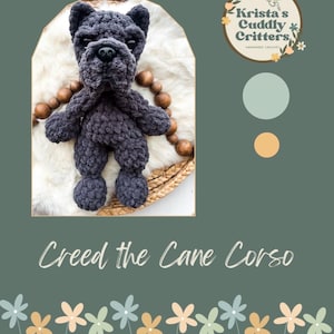 May include: A dark grey crocheted plush toy shaped like a Cane Corso dog with a black plastic nose and eyes. The toy is displayed within an arched frame alongside a logo reading Krista's Cuddly Critters and text stating Creed the Cane Corso.