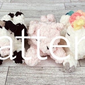 May include: Five crocheted stuffed animals, including a brown and white cow, a black and white cow, a pink pig, a white unicorn with a rainbow mane, and a brown and white sheep. The animals are lying down on a wooden surface. The word "Pattern" is written in white text across the middle of the image.