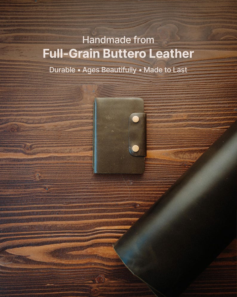 May include: A dark brown leather wallet featuring a vertical strap secured by two metallic snap buttons. The text above reads: Handmade from Full-Grain Buttero Leather. Durable &bull; Ages Beautifully &bull; Made to Last. The wallet is rectangular.