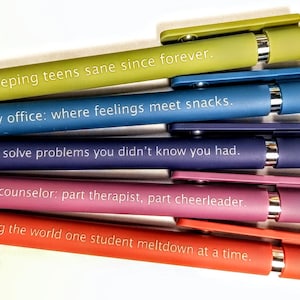 May include: A collection of colorful pens with humorous quotes. The pens are in shades of green, blue, purple, pink, and red. Each pen has a different quote in white text, such as "Keeping teens sane since forever."