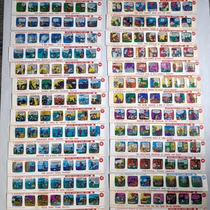 May include: A collection of vintage Disney slide cards, each featuring a different comic strip scene. The cards display colorful illustrations and text, with titles like "Tinker Bell Folds Pirate" and "Mickey Mouse in the Big Catch."