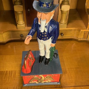 Cofrinho mecânico de ferro fundido Tio Sam vintage: decoração americana