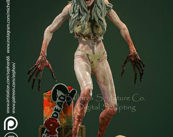 Może przedstawiać: Szczegółowa rzeźba zombie z gry Left 4 Dead 2. Postać ma bladą skórę, długie szare włosy i odsłonięte ciało. Rzeźba zawiera podstawę z czaszkami i logo gry.