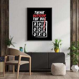 May include: A black and white motivational poster with the text "Think Outside The Box" and a tic-tac-toe board with a red X drawn outside the box.