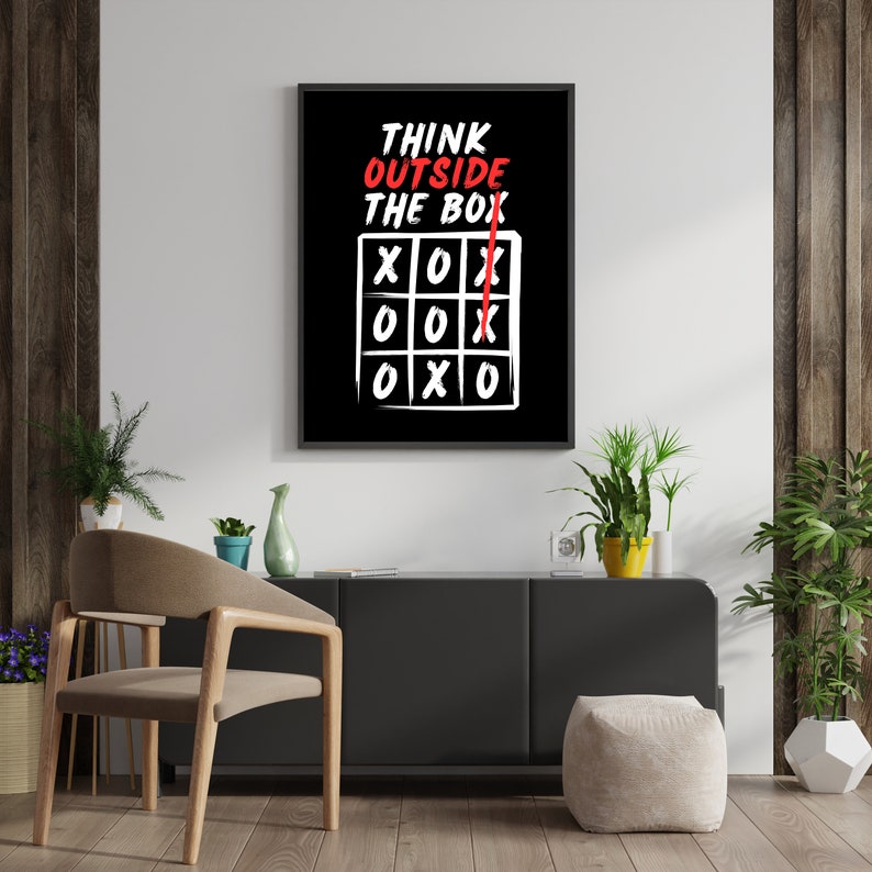 May include: A black and white motivational poster with the text "Think Outside The Box" and a tic-tac-toe board with a red X drawn outside the box.