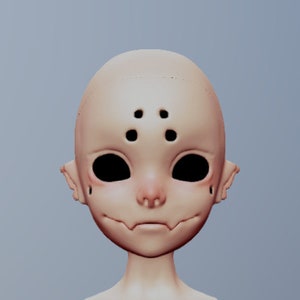 May include: A doll's head with a pale complexion and black eyes. The doll has four black dots on its forehead.