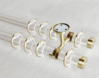 May include: Double curtain rod with clear acrylic tubes and gold metal end caps and brackets. The rod is designed for hanging curtains or drapes.