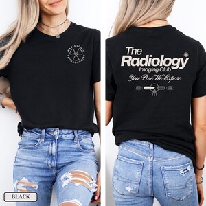 May include: Black t-shirt with a white graphic of a radiation symbol and the text "Radiologic Technologist". The back of the shirt has the text "The Radiology Imaging Club You Pose We Expose" in white.