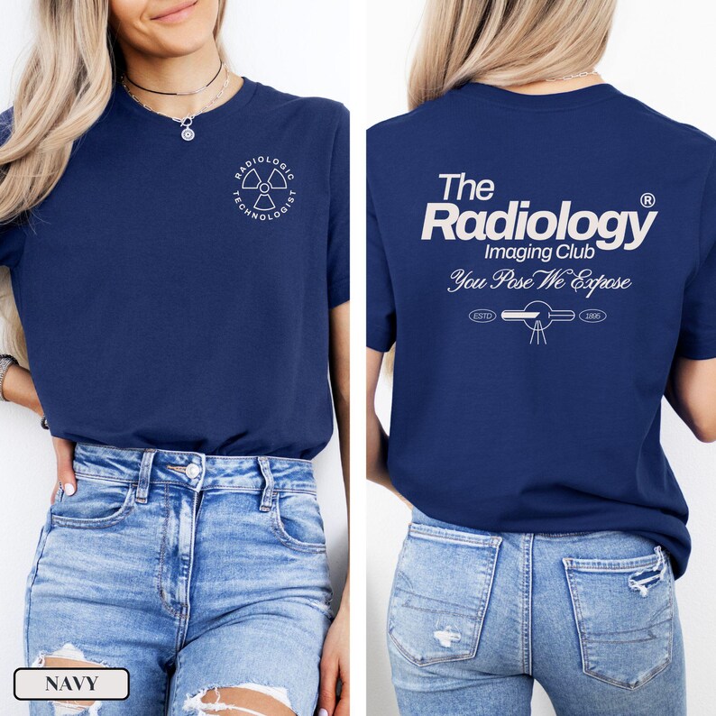 May include: A navy blue t-shirt with a white graphic on the front that says "Radiologic Technologist" and a white graphic on the back that says "The Radiology Imaging Club You Pose We Expose" with a stylized image of an x-ray machine.