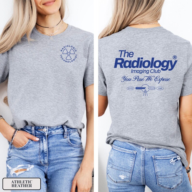 May include: A heather gray t-shirt with a blue graphic on the front that says "Radiologic Technologist" with a radiation symbol. The back of the shirt has a blue graphic that says "The Radiology Imaging Club You Pose We Expose" with a stylized image of an x-ray machine.