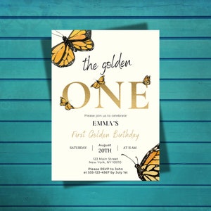 May include: A white invitation card with gold lettering that says "the golden ONE". The card has a butterfly design and text that says "Please join us to celebrate Emma's First Golden Birthday. Saturday, August 20th at 11 AM. 123 Main Street, New York, NY 10010. Please RSVP to John at 555-123-4567 by July 1st."