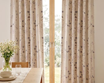 May include: A pair of floor-length pinch pleat curtains featuring a light beige fabric with a delicate watercolor-style botanical print in shades of muted purple, brown, and green, suspended from a silver metal rod with circular finials.
