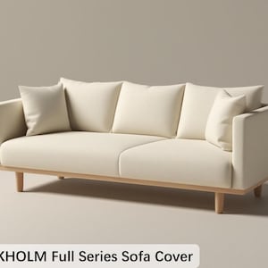 May include: Cream-colored sofa with four matching pillows. The sofa has a light wood frame and legs. The text "STOCKHOLM Full Series Sofa Cover" is at the bottom of the image. The sofa is a modern design.