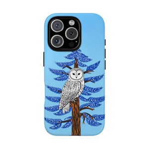 May include: A light blue phone case featuring a detailed illustration of a white owl perched on a brown tree with blue pine needles. The case has a glossy finish and is designed for a smartphone.