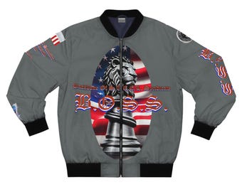 May include: Grey bomber jacket with black trim and a central oval design. The design features a lion chess piece set against the American flag. The word "BOSS" is displayed in a stylized font, with additional text visible.