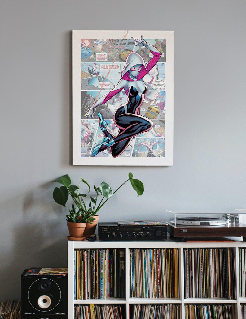 May include: A white and pink Spider-Gwen comic book character illustration with a white mask and black suit. The character is posed in mid-air with her arms raised and a web line attached to her wrist. The illustration is set against a comic book panel background.