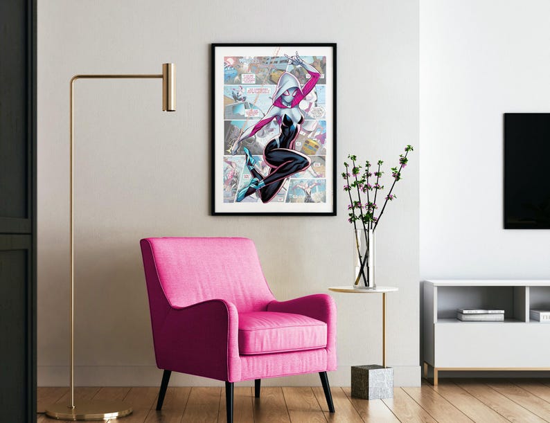 May include: A framed comic book art print featuring a female superhero in a white and black costume with a red spider symbol on her chest. The superhero is in mid-air, kicking with her right leg and holding her left arm out. The background is a comic book panel with a cityscape and other superheroes.