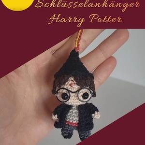 May include: A crocheted Harry Potter keychain. The figure is wearing round glasses, a black robe, and a Gryffindor scarf. The keychain is held against a burgundy background with text that reads "PDF Anleitung Schlüsselanhänger Harry Potter."