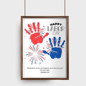 May include: A framed print with a brown wooden frame. The print features red and blue handprints, fireworks, and the text "HAPPY LABOR DAY." Below the text is a Bible verse.