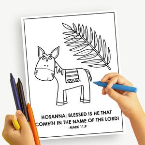 May include: Black and white line drawing of a donkey and palm branch, with the text "HOSANNA; BLESSED IS HE THAT COMETH IN THE NAME OF THE LORD! -MARK 11:9". A child's hand holds a blue crayon, ready to color the image.
