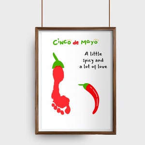 May include: A framed print with a Cinco de Mayo theme. The artwork features a red footprint shaped like a chili pepper, a curved red chili pepper, and the text "A little spicy and a lot of love."