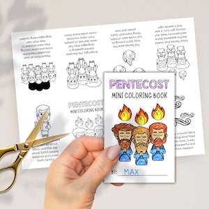May include: A mini coloring book titled "Pentecost" is held near a pair of gold scissors. The book features illustrations of flames and figures, with the text "Mini Coloring Book" and "By: Max".